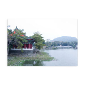 Traditional red-roofed Confucius temple pavilion beside a misty lake in Kaohsiung Taiwan, original photography postcard print