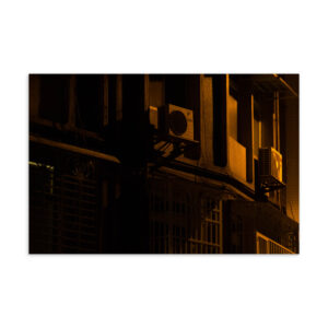 Taipei building facade at night lit by warm golden streetlight, original photography postcard print