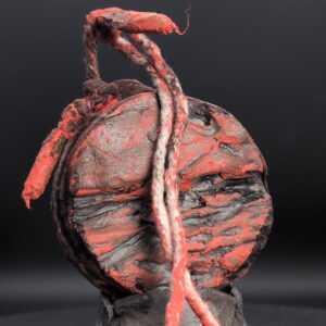 Handmade clay spirit vessel with red and charcoal disc face and looped rope cord
